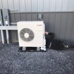 small solutions team member working on a ductless mini split aircon